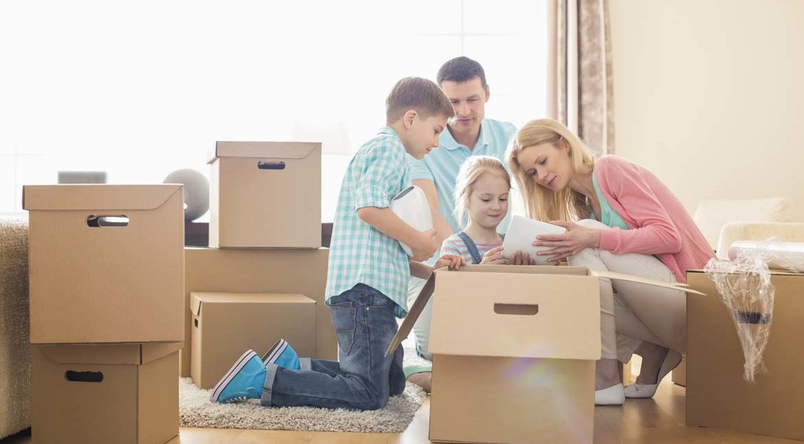 family-opening-moving-boxes