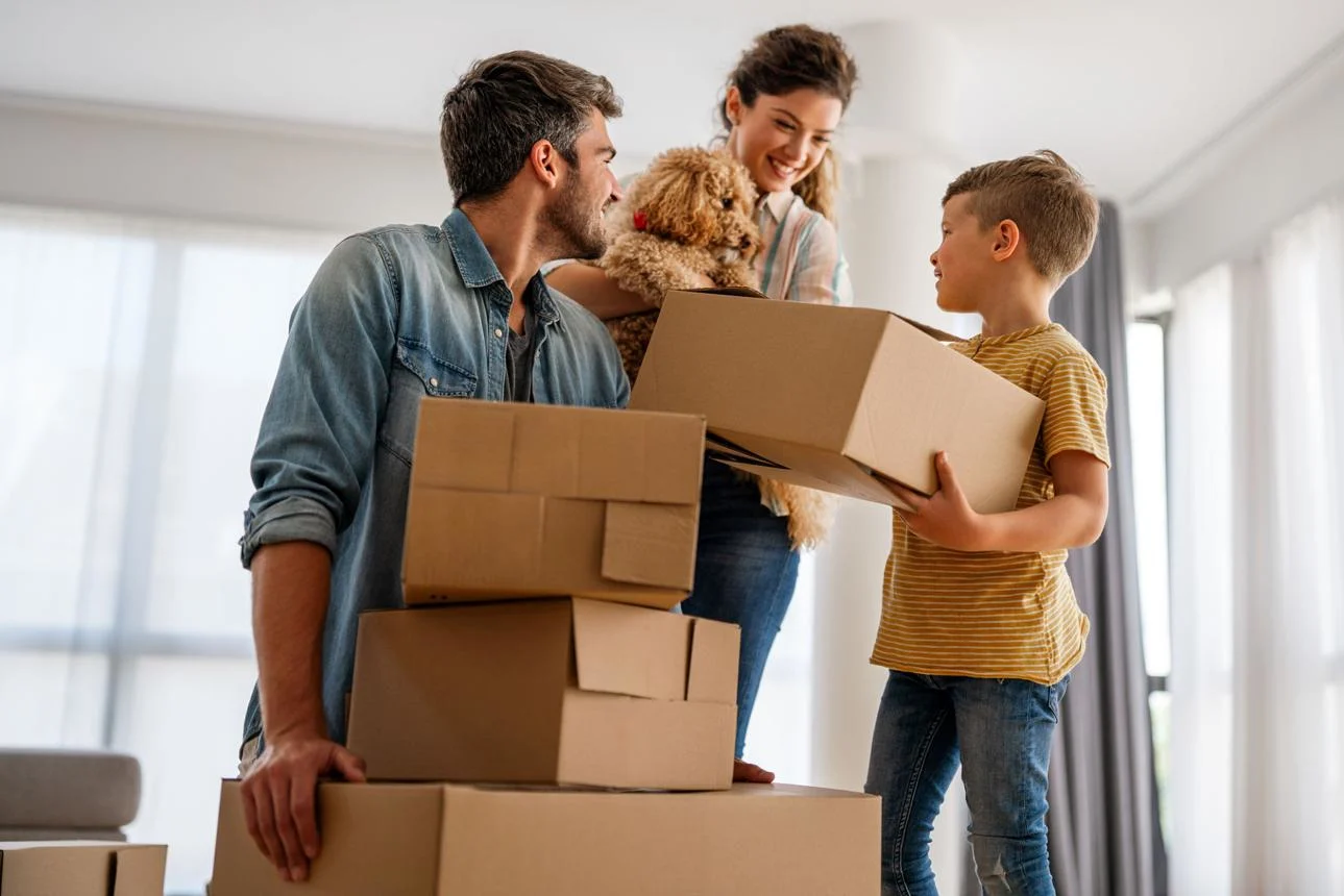 Happy family arriving at their new home after a successful local move with professional movers.