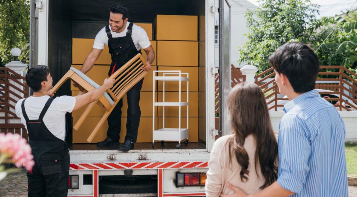 Professional movers loading furniture into a moving truck
