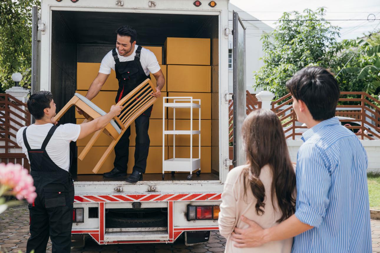 Professional movers loading furniture into a moving truck