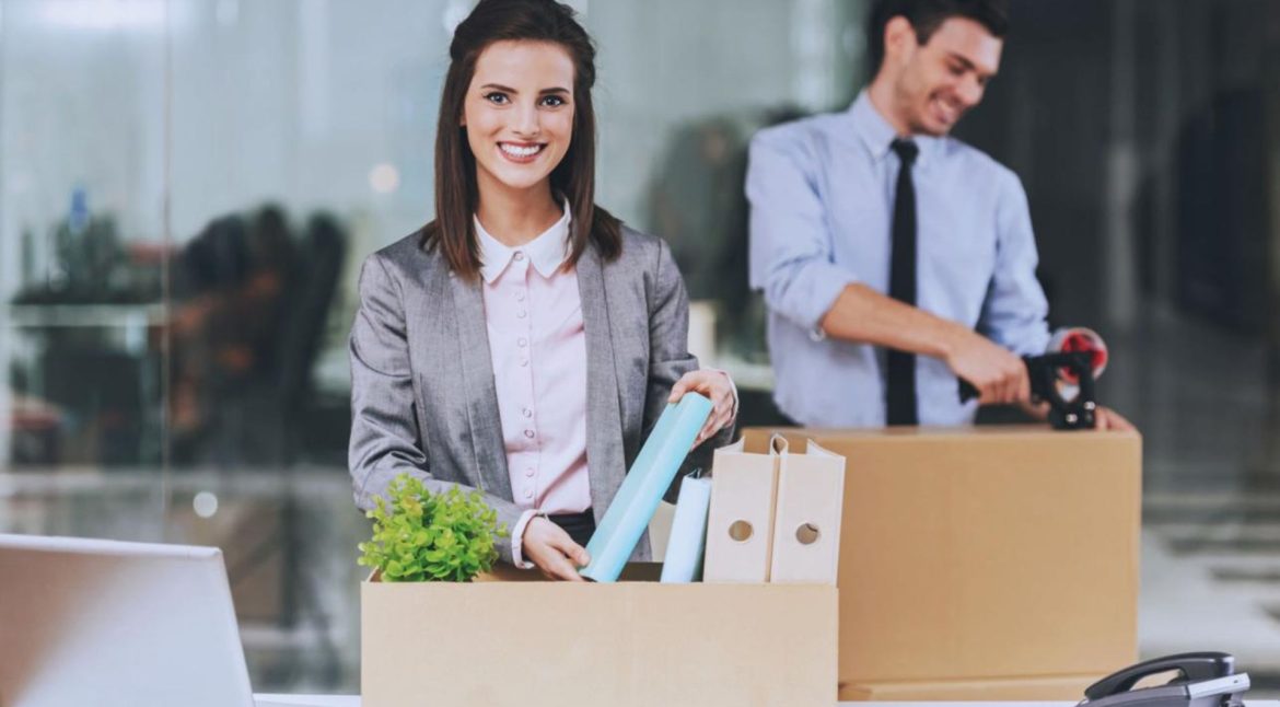 Commercial movers transporting office furniture and equipment during a business relocation