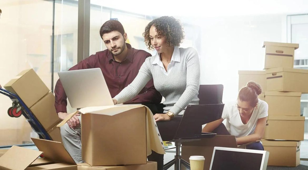 Commercial movers transporting office furniture and equipment during a business relocation