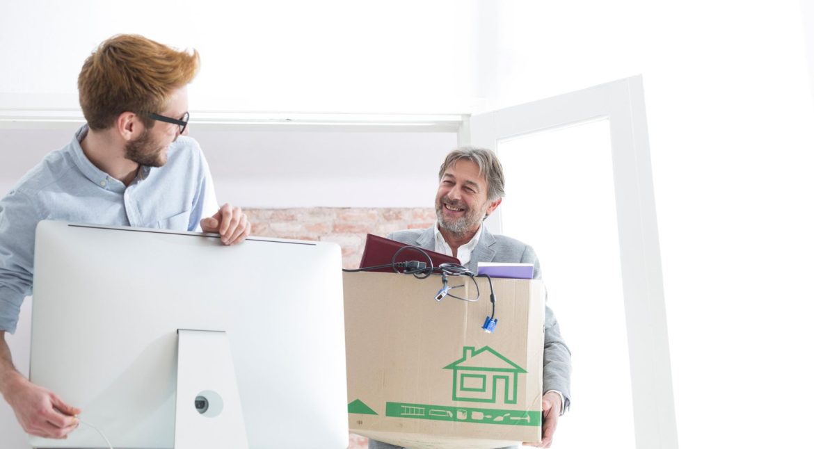 Employees setting up workstations and technology after an office relocation