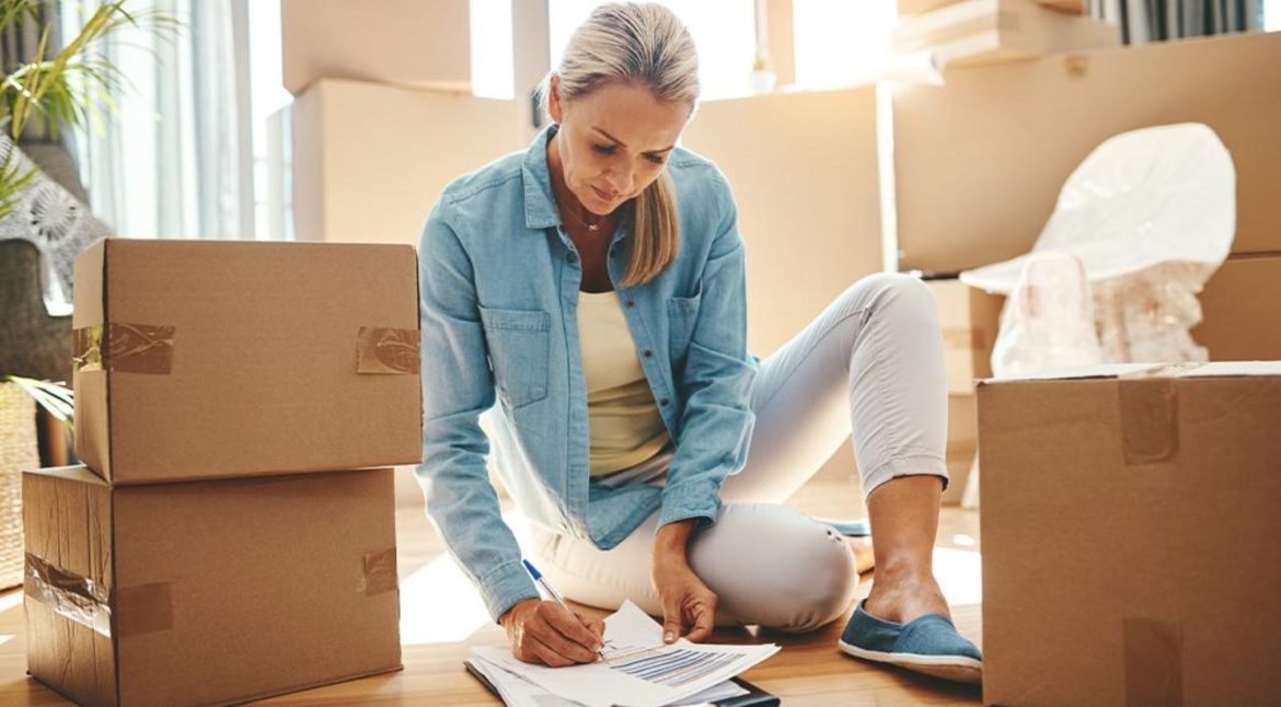 Homeowner sorting items into keep donate sell and discard categories before moving