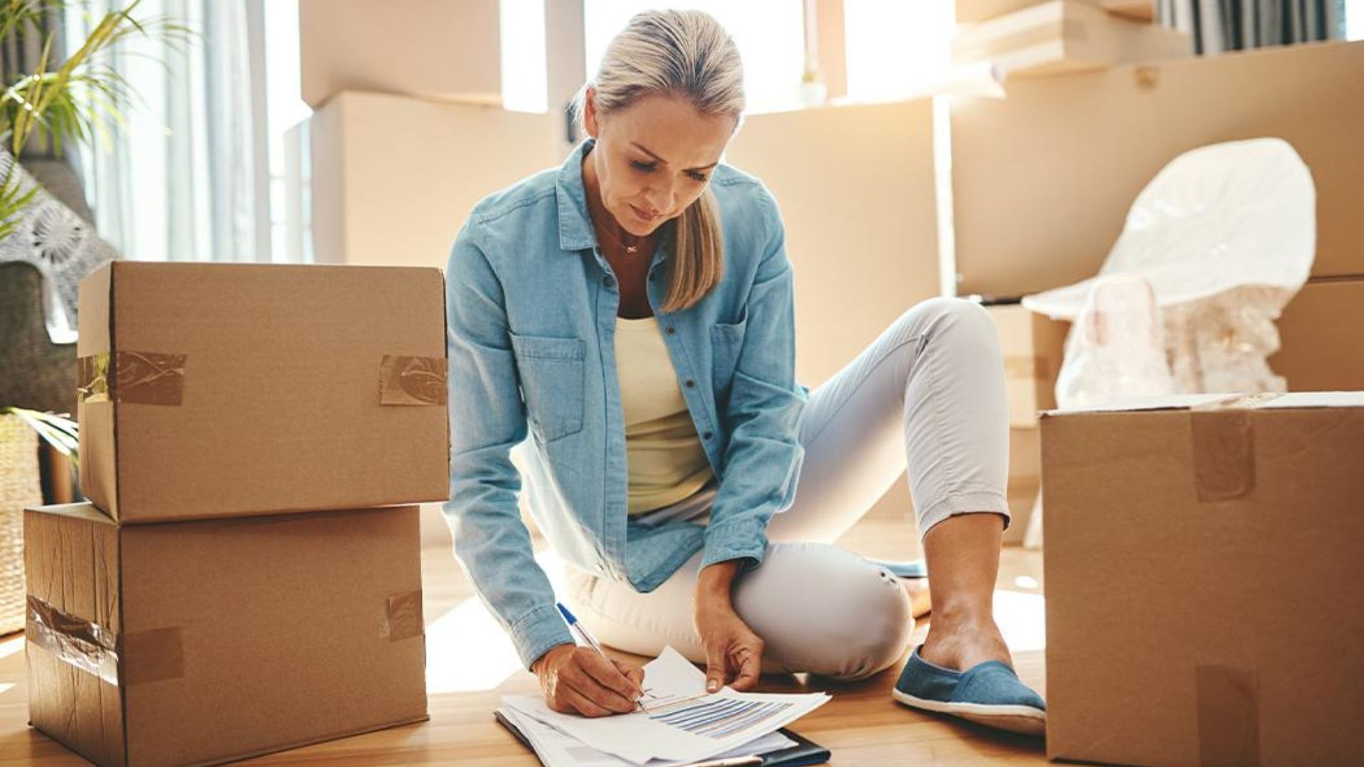 Homeowner sorting items into keep donate sell and discard categories before moving