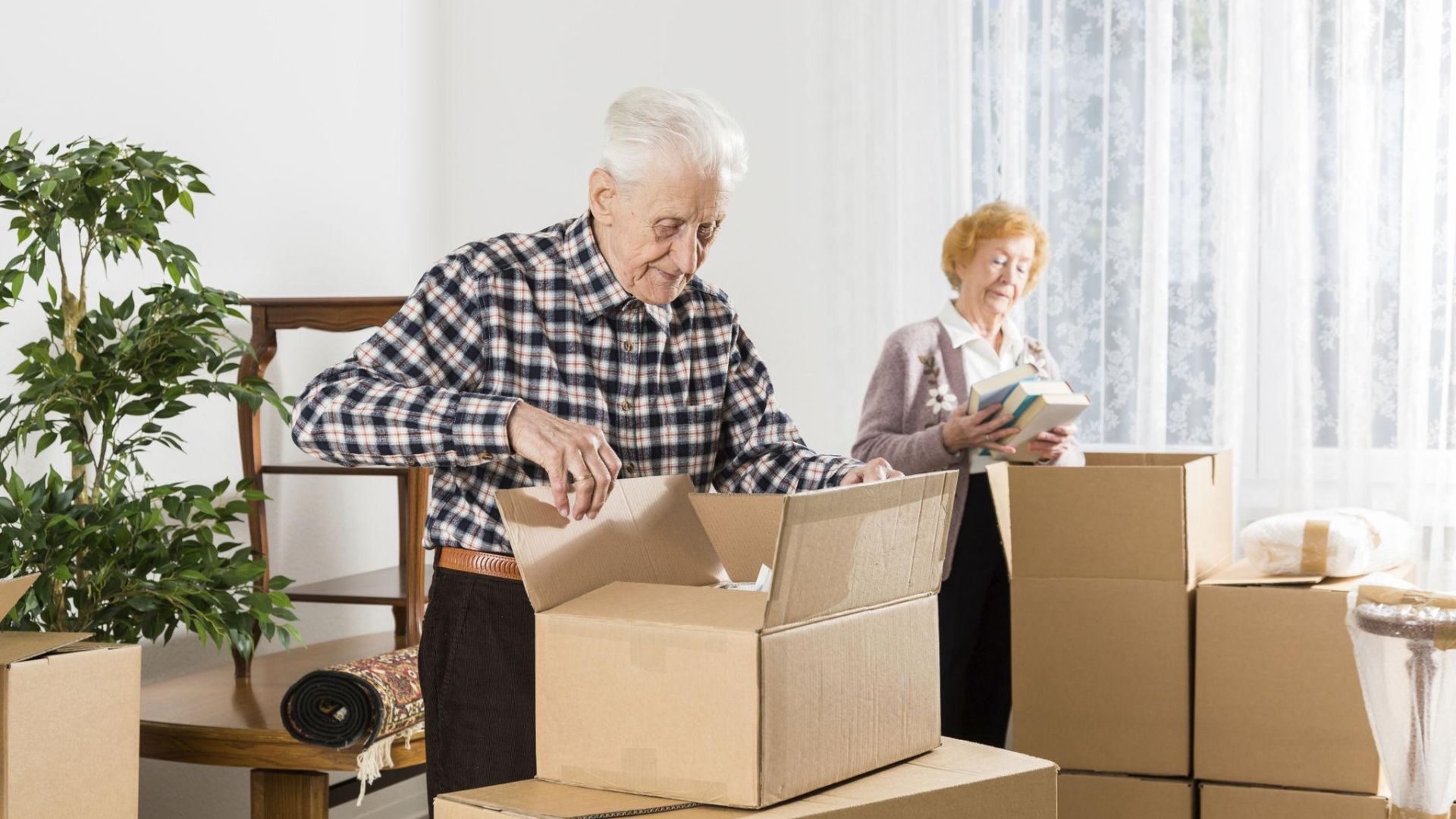 Movers unpacking boxes and organizing belongings inside a new home