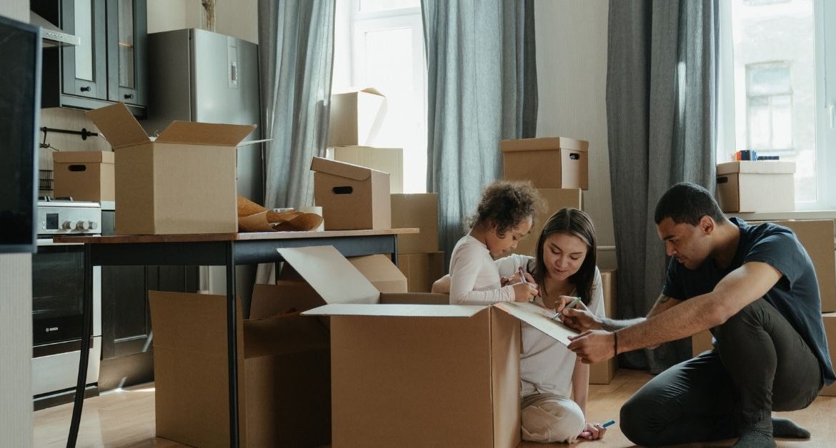 Family planning an interstate move using a checklist and moving timeline to stay organized