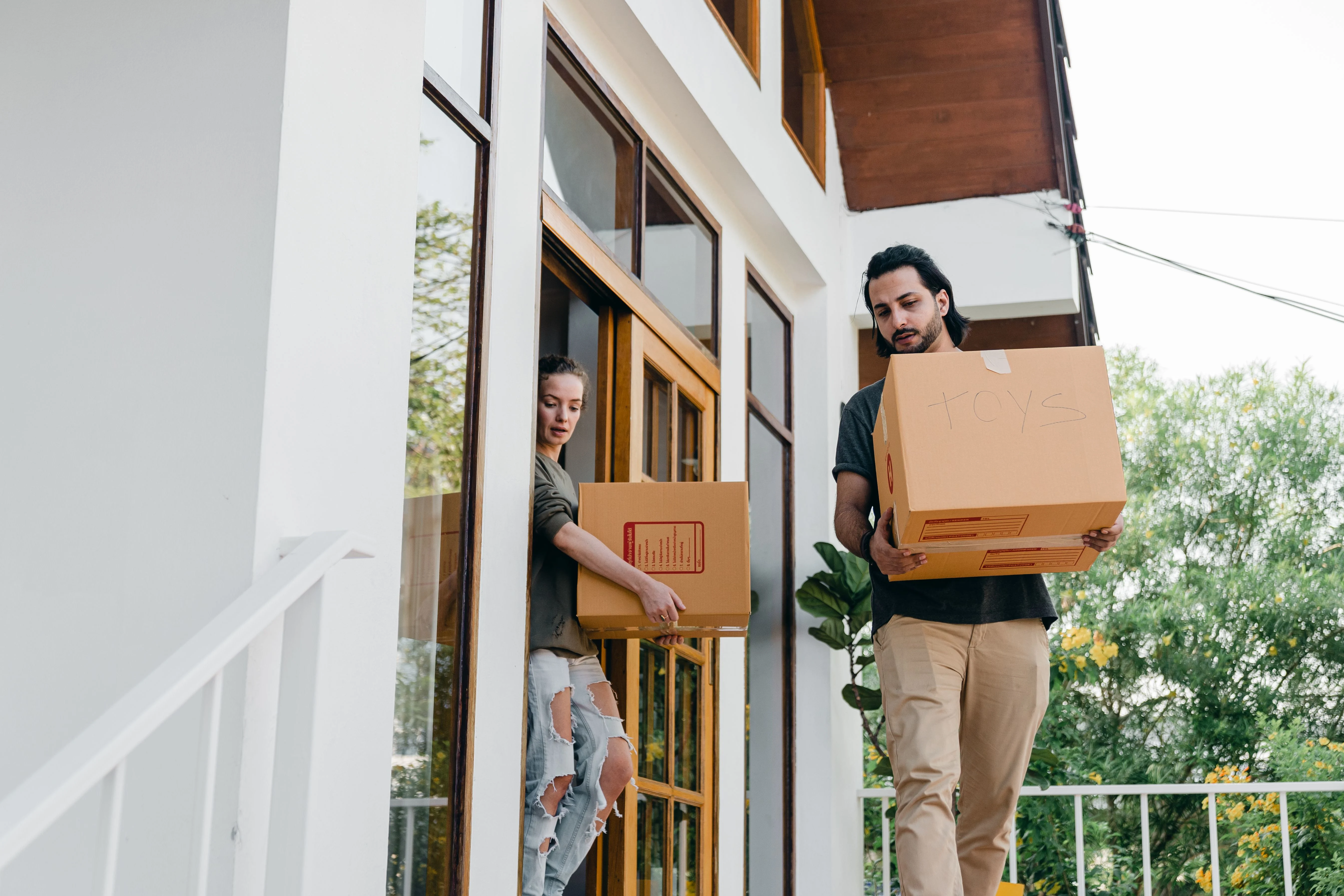 Happy family arriving at their new home after a successful long-distance move with professional packing, transport, and delivery services.