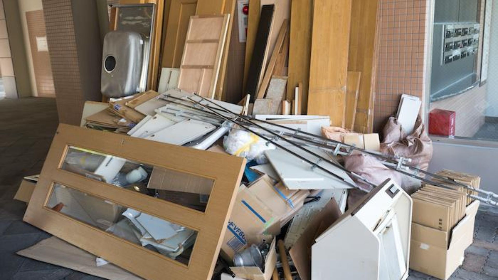 Cluttered garage being cleaned and organized by junk removal professionals