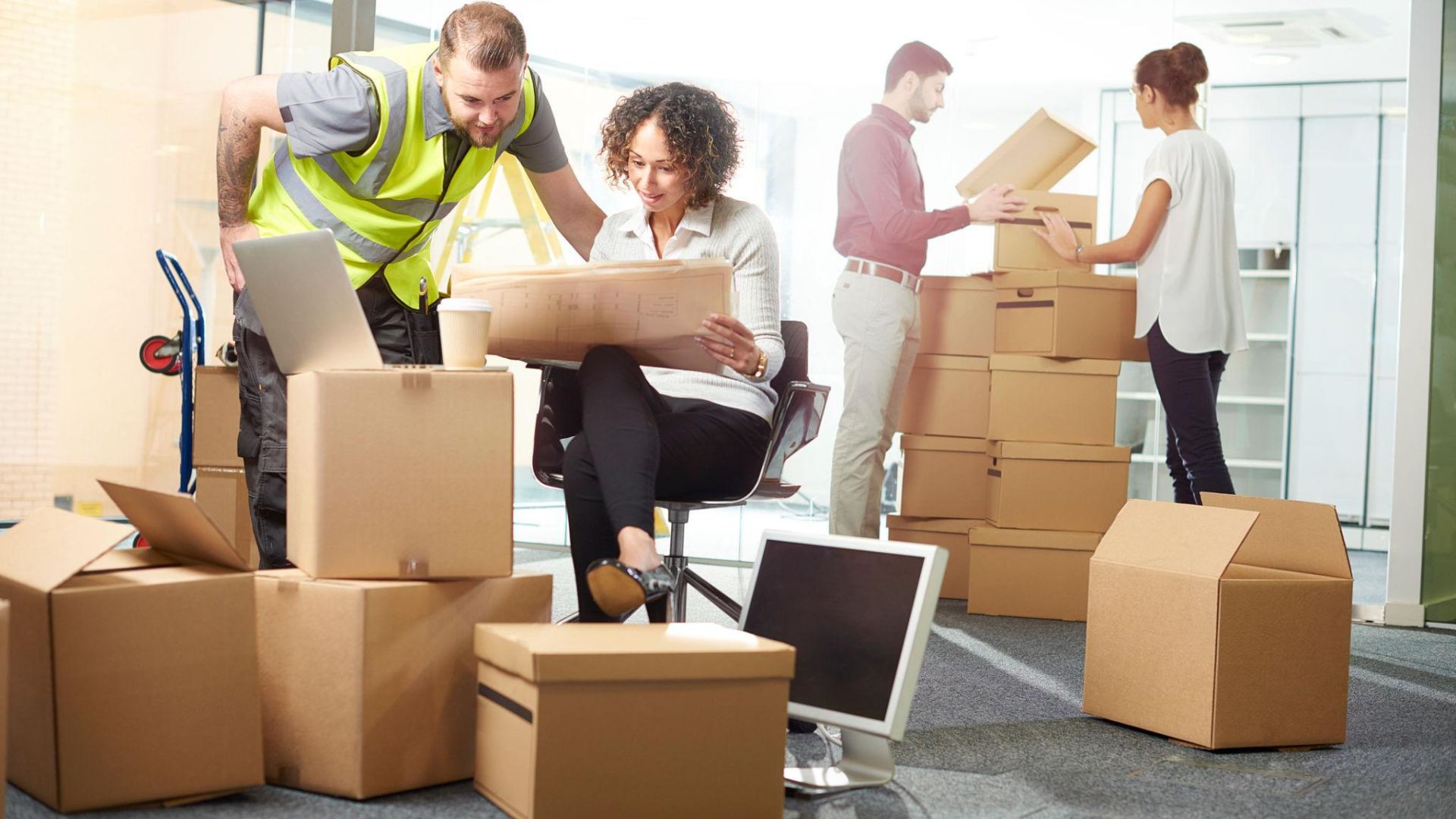 Commercial movers relocating office furniture during a weekend business move