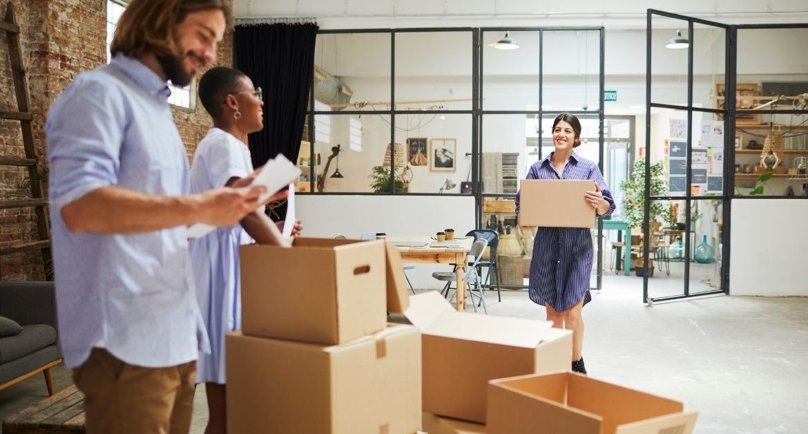 Employees carrying office files and materials during a well-organized office relocation to a new workspace